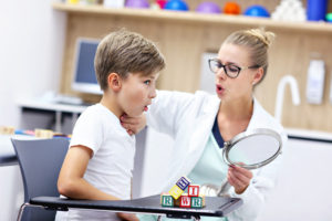 speech-therapist-working-with-young-boy-in-the-classroom